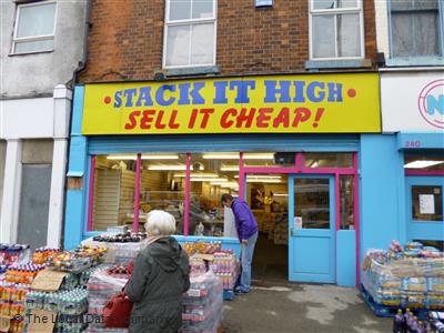 A shop selling off products very cheaply, stacked together, no shelves.
